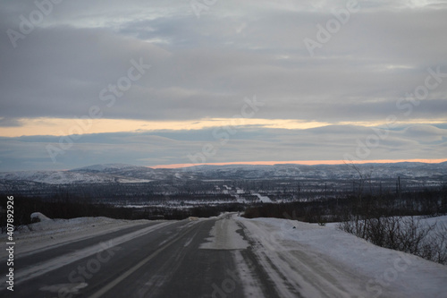 dawn on a winter road with clouds