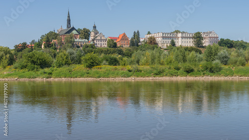 Historical royal city on the bank of the Vistula river - panoramic view from riverboat cruise, Sandomierz, Poland