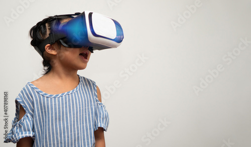 Little Asian girl child with virtual reality headset is exciting for new experiencing. Concept of 3D gadget technology and virtual world gadgets game and online education in the future