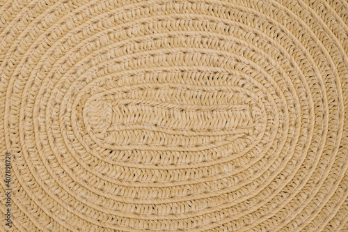 A weave pattern of a vintage paper straw hat. The texture of dried paper straw as a background