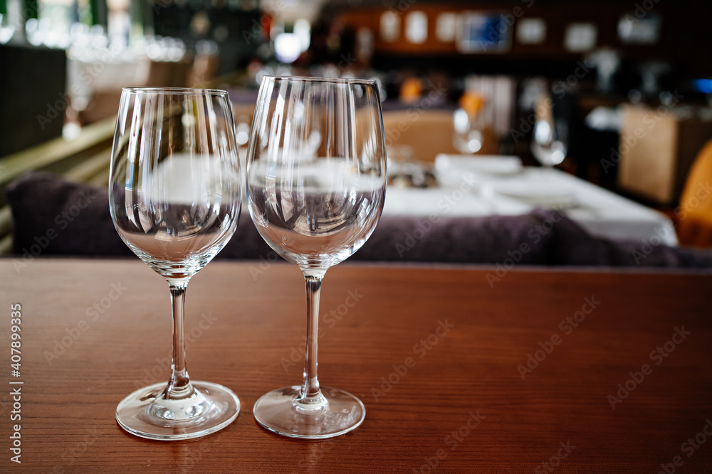 two empty clean wine glasses on a wooden table. utensils for alcoholic beverages. serving the table.