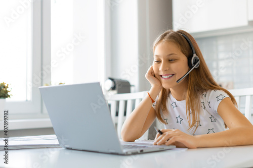 Teenager girl during online video call. Homework online.