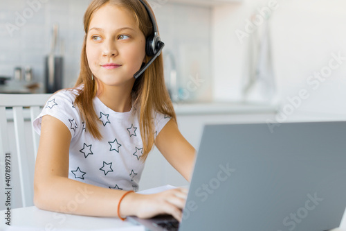 Teenager girl during online video call. Homework online.