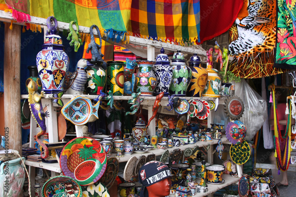 Mexican culture - a shelf with folk products on the market. Hand painted vases, mugs, plates, bowls mugs.