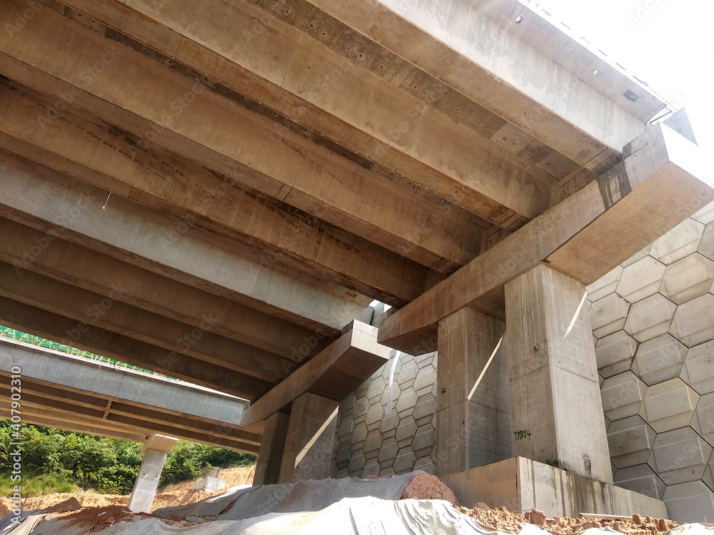 PENANG, MALAYSIA - MARCH 21, 2020: Overhead road under construction. The massive concrete column used to support the concrete road deck. Construction work is in full swing. PENANG, MALAYSIA - MARCH 21, 2020: Overhead road under construction. The massive concrete column used to support the concrete road deck. Construction work is in full swing.