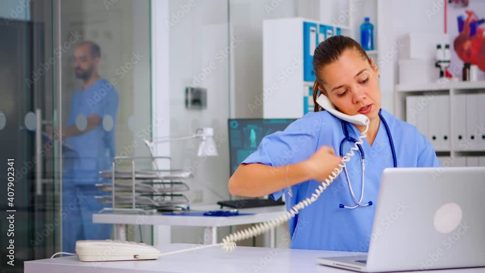 Medical assistant speaking at phone with patient analysing radiographics discussing the diagnosis, making new appointment. Healthcare physician, doctor nurse helping with telehealth communication Medical assistant speaking at phone with patient analysing radiographics discussing the diagnosis, making new appointment. Healthcare physician, doctor nurse helping with telehealth communication