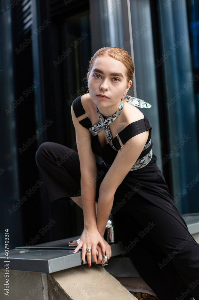 White young woman in black clothes urban style