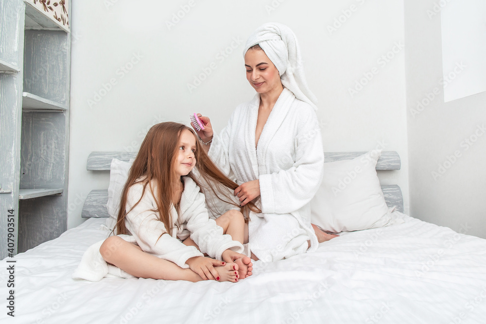 happy mom and daughter after shower. Beauty hair care concept happy mom and daughter after shower. Beauty hair care concept