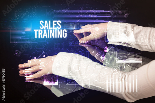 Businessman touching huge screen with SALES TRAINING inscription  cyber business concept
