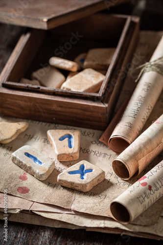 Antique futhark rune stones, old manuscript and scrolls