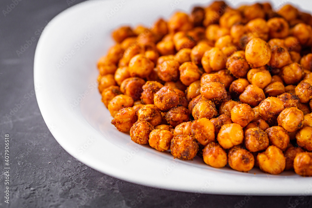 fried chickpeas on a dark stone background fried chickpeas on a dark stone background
