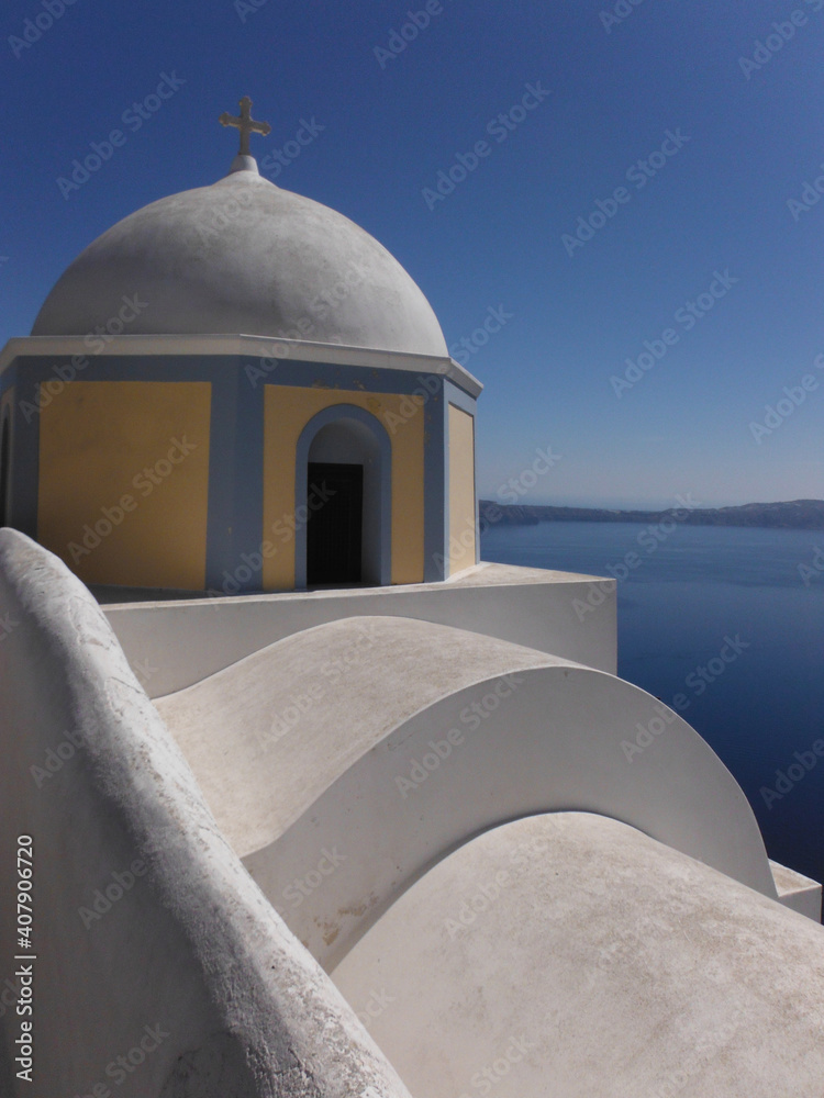 View of Santorini from above with a white facade in the foreground and the sea and deep blue sky in the background
Conceptual of tourism, vacation, traveling, mediterranean sea