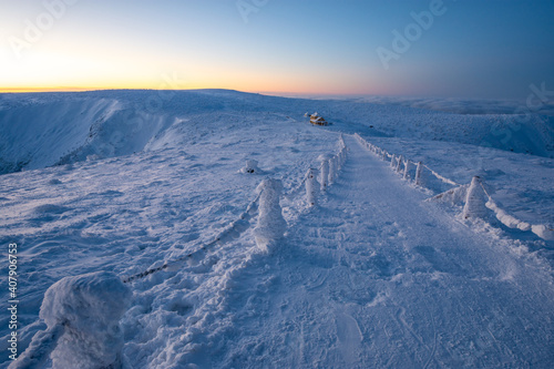 path way in Karkonosze mountains during winter sunset in Poland