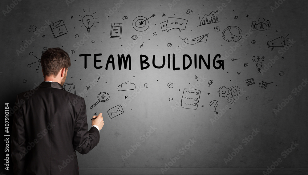 businessman drawing a creative idea sketch with TEAM BUILDING inscription, business strategy concept businessman drawing a creative idea sketch with TEAM BUILDING inscription, business strategy concept