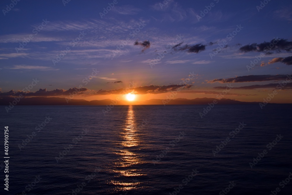 beautiful sunset over the sea with Sardinia island in Italy in the background beautiful sunset over the sea with Sardinia island in Italy in the background