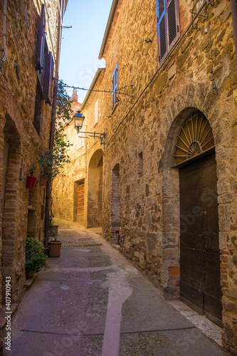 A street of historic stone buildings in the village of Montemerano near Manciano in Grosseto province, Tuscany, Italy 