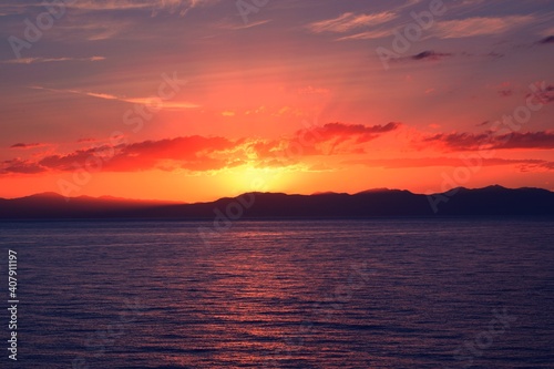 beautiful sunset over the sea with Sardinia island in Italy in the background