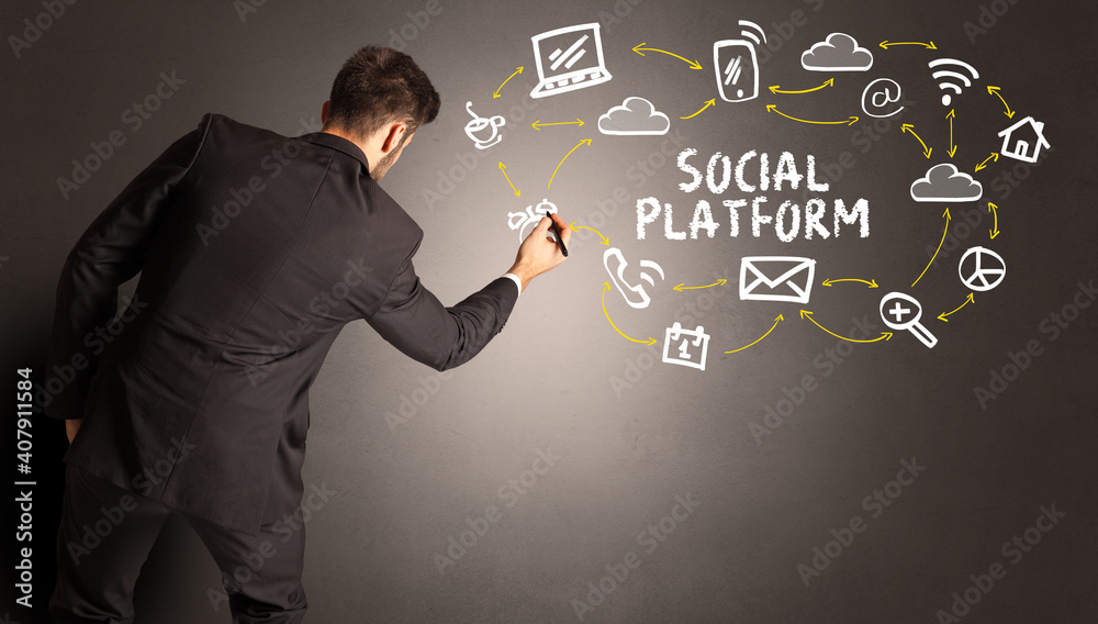 businessman drawing social media icons with SOCIAL PLATFORM inscription, new media concept