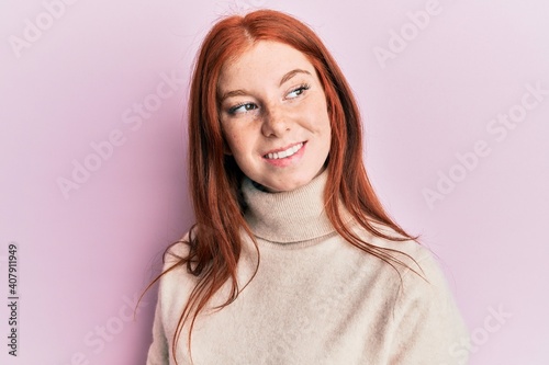 Fotografija Young red head girl wearing turtleneck sweater looking to side, relax profile pose with natural face and confident smile