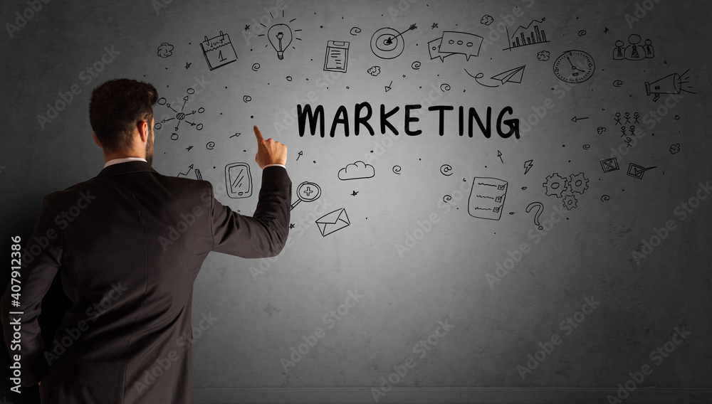 businessman drawing a creative idea sketch with MARKETING inscription, business strategy concept businessman drawing a creative idea sketch with MARKETING inscription, business strategy concept