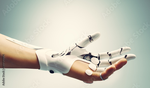 Robotic bionic hand connected with human hand. photo