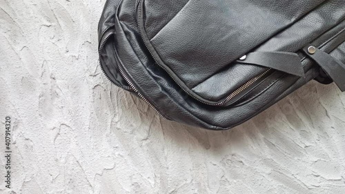 Stop motion animation. Black backpack with office supplies, disinfectant and medical protective mask, wallet and apple. Back to school, student recruitment or to work after quarantine.