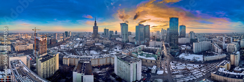 Beautiful panoramic aerial drone view on All Saints Church - Roman Catholic church located at Grzybowski Square, Warsaw City Skyscrapers, PKiN, and Varso Tower under construction. Warsaw, Poland