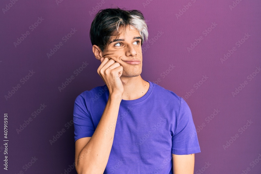 Young hispanic man wearing casual clothes thinking concentrated about doubt with finger on chin and looking up wondering Young hispanic man wearing casual clothes thinking concentrated about doubt with finger on chin and looking up wondering