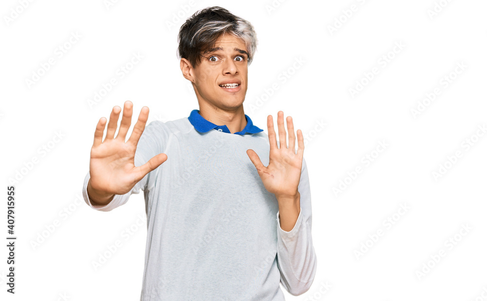 © Krakenimages.com - Young hispanic man wearing casual clothes afraid and terrified with fear expression stop gesture with hands, shouting in shock. panic concept. © Krakenimages.com - Young hispanic man wearing casual clothes afraid and terrified with fear expression stop gesture with hands, shouting in shock. panic concept.