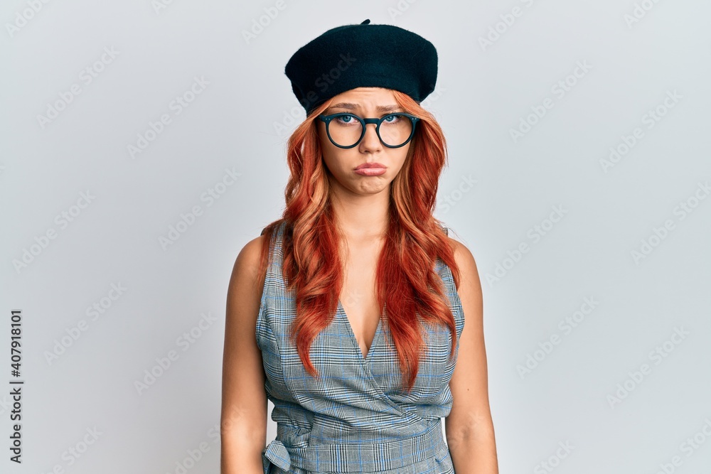 Young redhead woman wearing fashion french look with beret depressed and worry for distress, crying angry and afraid. sad expression. Young redhead woman wearing fashion french look with beret depressed and worry for distress, crying angry and afraid. sad expression.