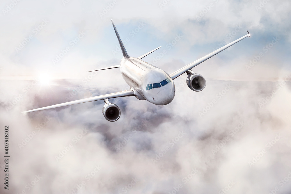 Obraz premium Airplane flying through the air above the clouds