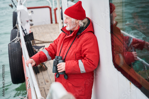 Seaman standing at the deck and looking away