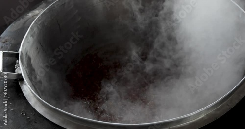 Bambara Groundnuts or Vigna subterranea boiling on metal vat steaming in Luhya Kenya, Handheld top view shot photo