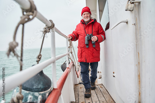 Fisherman walking through the boat while preparing to fishing photo