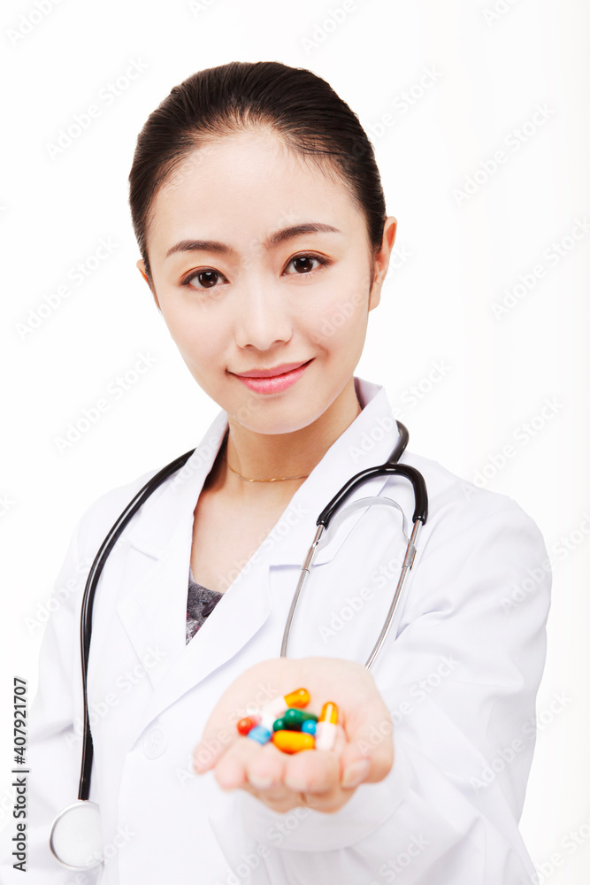 The young female doctor holding a pill The young female doctor holding a pill