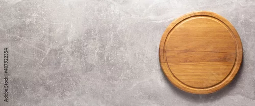 Panel kuchenny z motywem Pizza or bread cutting board for homemade baking on table. Food recipe concept at stone background texture