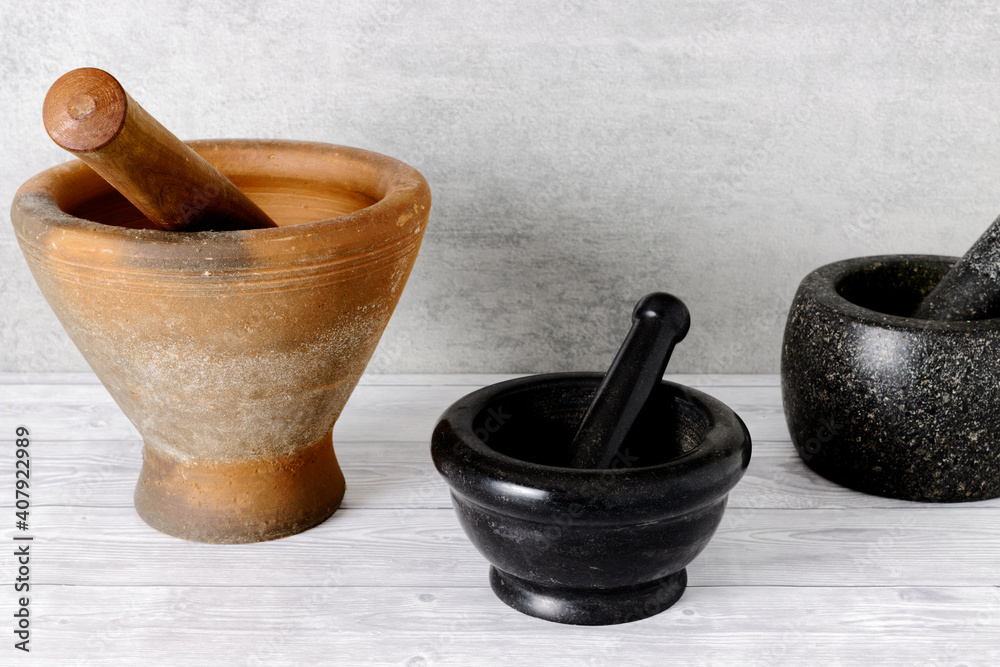 Mortars of different sizes and materials. One Thai clay mortar with
