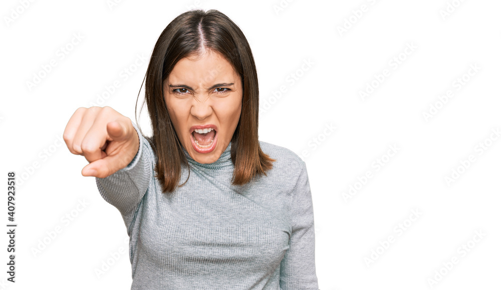 Young beautiful woman wearing casual turtleneck sweater pointing displeased and frustrated to the camera, angry and furious with you Young beautiful woman wearing casual turtleneck sweater pointing displeased and frustrated to the camera, angry and furious with you