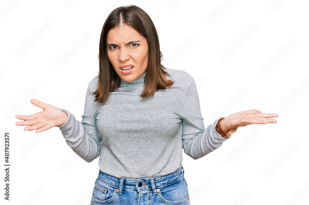 Young beautiful woman wearing casual turtleneck sweater clueless and confused with open arms, no idea concept. Young beautiful woman wearing casual turtleneck sweater clueless and confused with open arms, no idea concept.