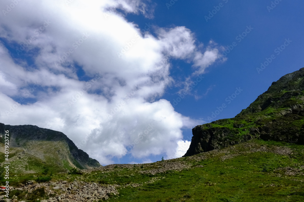 mountain with green hills and rocks while hiking in the summer mountain with green hills and rocks while hiking in the summer