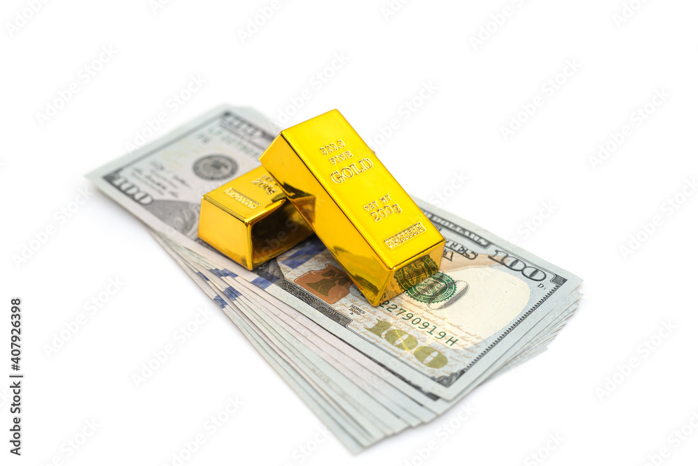 gold bars on a pile of US dollar banknotes gold bars on a pile of US dollar banknotes