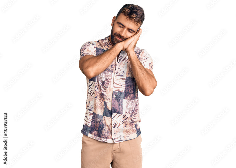 Young hispanic man wearing summer clothes sleeping tired dreaming and posing with hands together while smiling with closed eyes. Young hispanic man wearing summer clothes sleeping tired dreaming and posing with hands together while smiling with closed eyes.