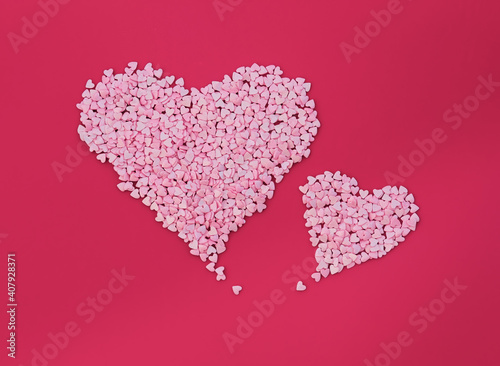 Two big hearts made of small hearts on red background. Love minimal concept