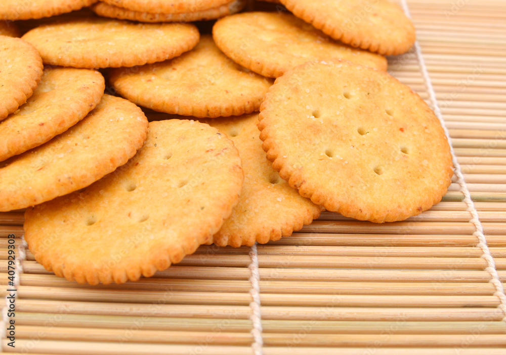 Delicious crackers isolated on bamboo mat Delicious crackers isolated on bamboo mat