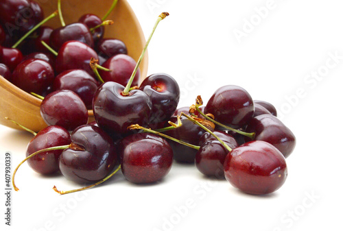 Cherry in wooden bowl isolated on white background