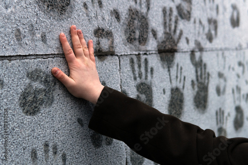 Young girl puts her hand on a frosted wall to leave a print in support of Alexei Navalny during a rally against his arrest in Moscow on January 23, 2021. photo