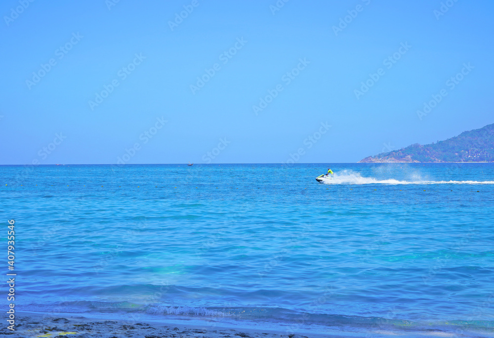 turquoise sea with a white boat that rushes through the waves, leaving a white, foam trace. For travel agencies.