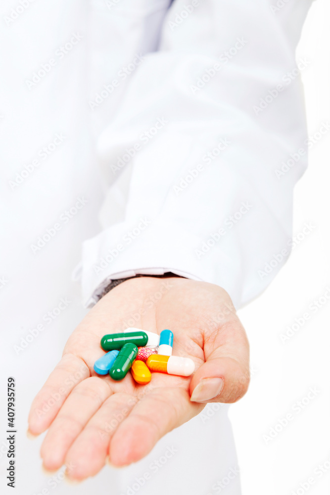 The young female doctor holding a pill The young female doctor holding a pill