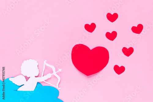 valentines day consept. red hearts and cupid aiming in heart on pink background. valentine's day card.