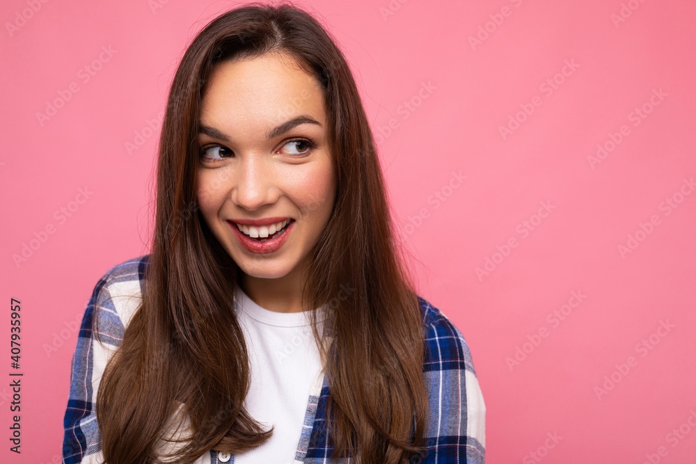 Photo portrait of young beautiful smiling hipster brunette woman in trendy blue and white shirt and jeans clothes. Sexy carefree female person posing isolated near pink wall with empty space in studio Photo portrait of young beautiful smiling hipster brunette woman in trendy blue and white shirt and jeans clothes. Sexy carefree female person posing isolated near pink wall with empty space in studio